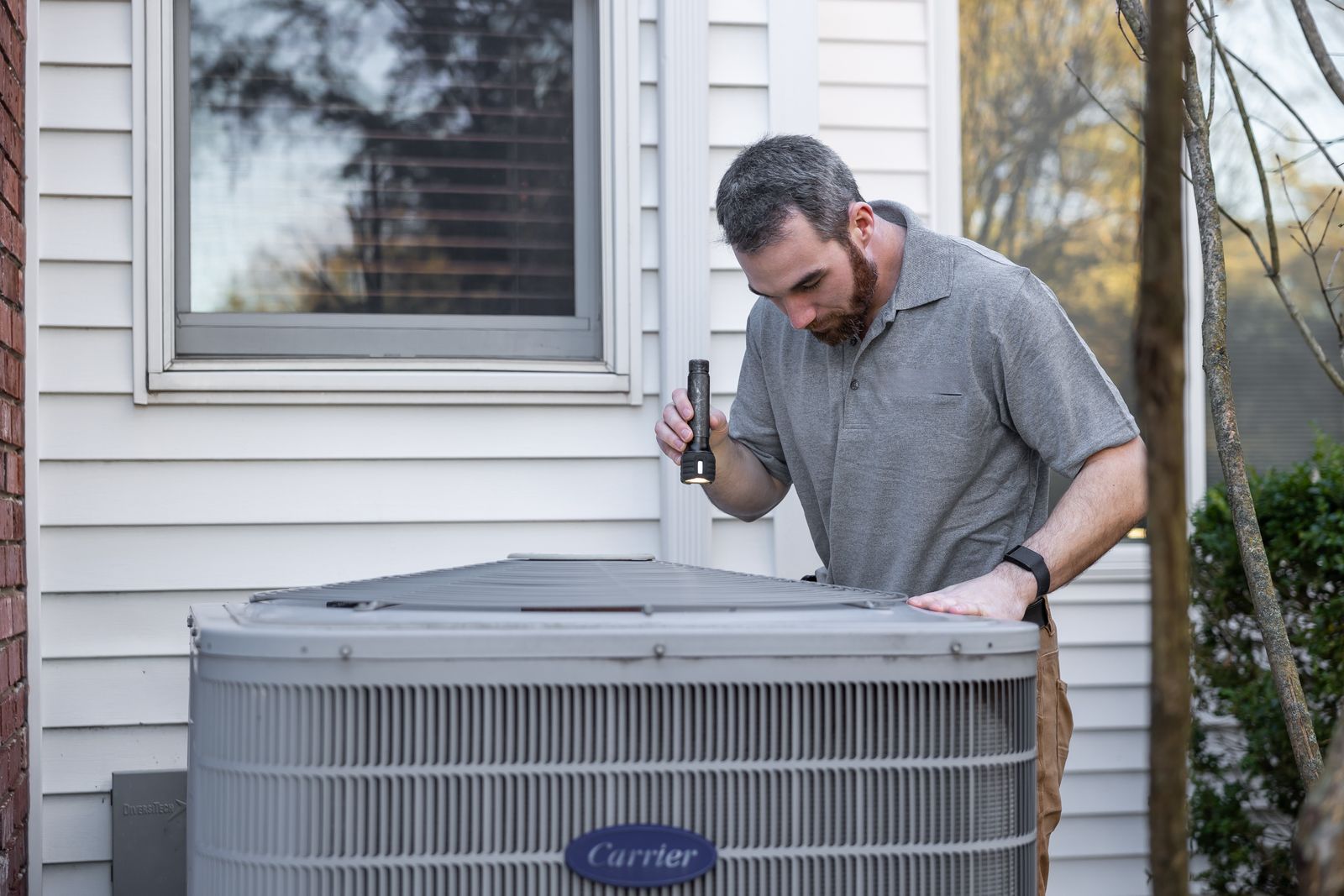 HVAC technician at work on a unit